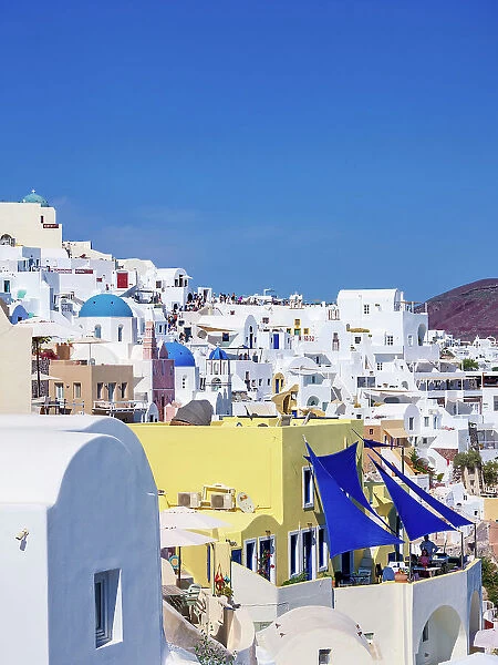 View towards the blue domed churches of Resurrection of the Lord and Saint Spyridon, Oia Village, Santorini (Thira) Island, Cyclades, Greek Islands, Greece, Europe