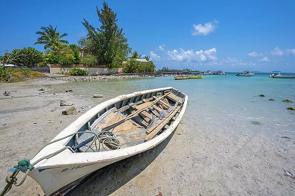 View of boat on beach and turquoise Indian Ocean on sunny day near Poste Lafayette, Mauritius, Indian Ocean, Africa