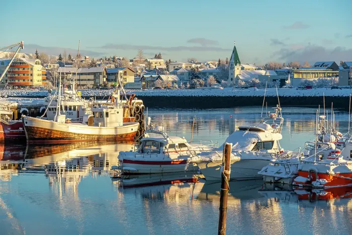 Framed Print : View of boats in Hafnarfjorour Marina and town in background in winter, Hafnarfjorour, Iceland