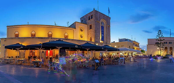 View of cafe and restaurant in Eleftherias Central Square in Kos Town at dusk, Kos, Dodecanese, Greek Islands, Greece, Europe
