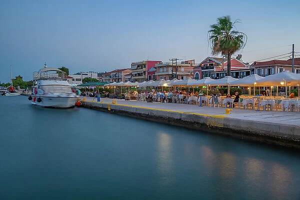 View of cafe and restaurant at the harbour at dusk, Lixouri, Kefalonia, Ionian Islands, Greek Islands, Greece, Europe