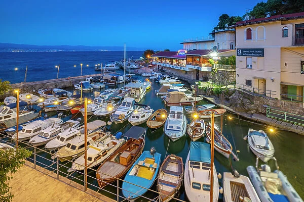View of cafe and restaurant overlooking harbour at dusk, Lovran village, Lovran, Kvarner Bay, Eastern Istria, Croatia, Europe