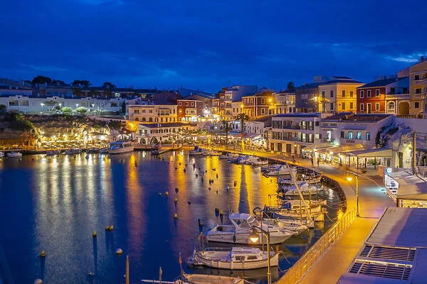 View of cafes, restaurants and boats in harbour at dusk, Cales Fonts, Es Castell, Menorca, Balearic Islands, Spain, Mediterranean, Europe