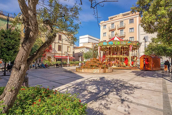 View of carousel and fountain on Piazza Matteotti on sunny day in Olbia, Olbia, Sardinia, Italy, Mediterranean, Europe