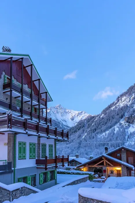 Framed Print : View of chalets and snow covered mountains in Courmayeur before dawn in winter, Courmayeur, Aosta Valley, Italian Alps, Italy