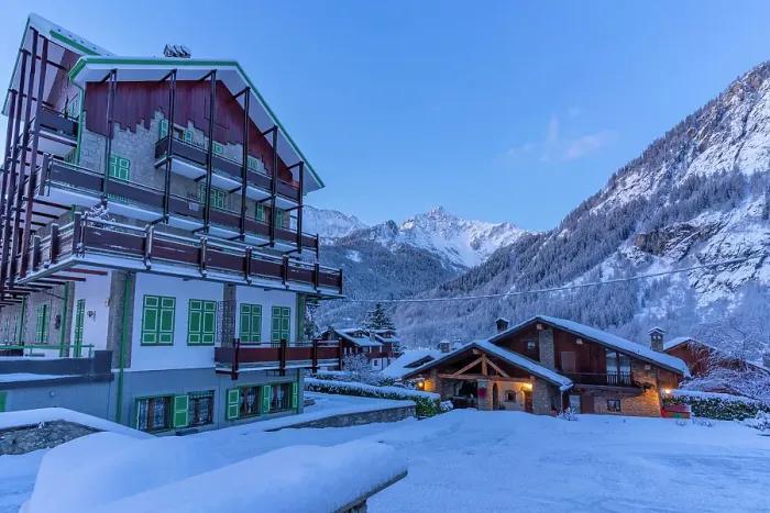 Framed Print : View of chalets and snow covered mountains in Courmayeur before dawn in winter, Courmayeur, Aosta Valley, Italian Alps, Italy
