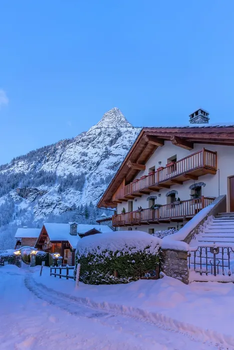 Framed Print : View of chalets and snow covered mountains in Courmayeur before dawn in winter, Courmayeur, Aosta Valley, Italian Alps, Italy