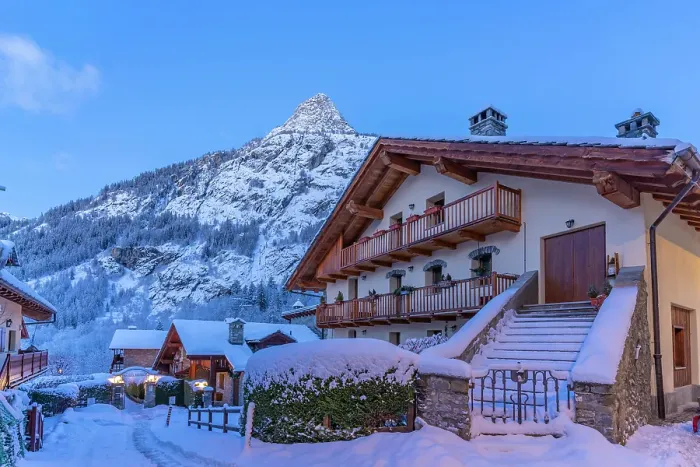 Framed Print : View of chalets and snow covered mountains in Courmayeur before dawn in winter, Courmayeur, Aosta Valley, Italian Alps, Italy