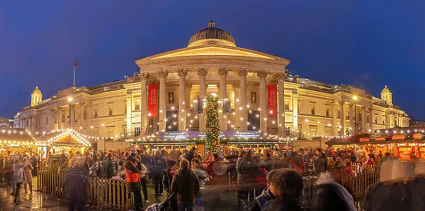 View of Christmas market and The National Gallery in Trafalgar Square at dusk, Westminster, London, England, United Kingdom, Europe