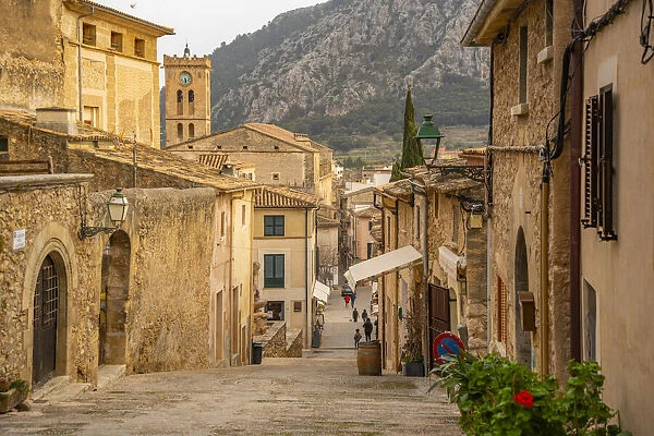 View of church clock tower and street in the old town of Pollenca, Pollenca, Majorca, Balearic Islands, Spain, Mediterranean, Europe