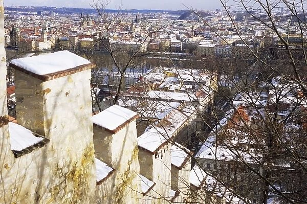 View of city from snow covered Gothic Hunger Wall on Petrin Hill, Mala Strana