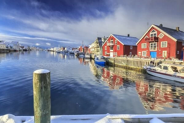 View of colorful fishermens houses and private boats overlooking the canal-port of Henningsvaer, Lofoten Islands, Arctic, Norway, Scandinavia, Europe