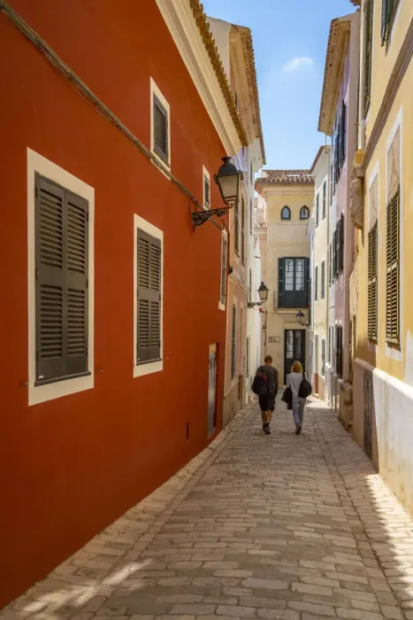 Framed Print : View of couple walking down pastel coloured street in historic centre, Ciutadella, Menorca, Balearic Islands, Spain, Mediterranean, Europe Framed Print : View of couple walking down pastel coloured street in historic centre, Ciutadella, Menorca, Balearic Islands, Spain, Mediterranean, Europe