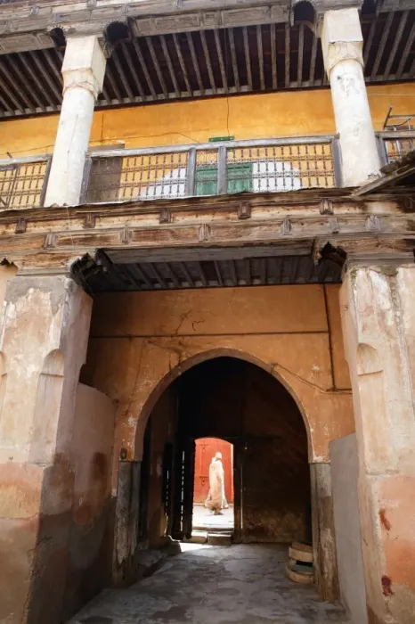 Framed Print : View out from courtyard with figure walking by Framed Print : View out from courtyard with figure walking by