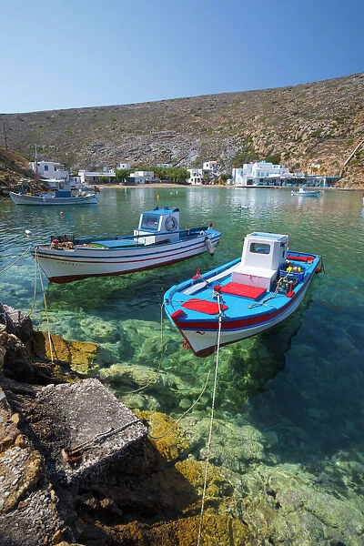 View over crystal clear water and fishing boats in harbour, Cheronissos, Sifnos, Cyclades