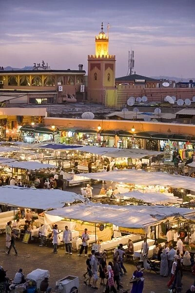 View over Djemaa el Fna at dusk with foodstalls that are set-up daily to serve tourists