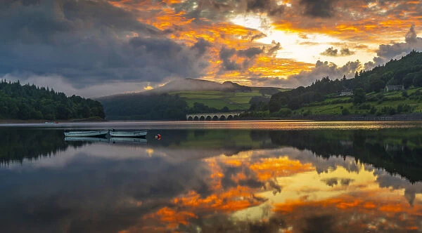 View of dramatic clouds reflecting in Ladybower Reservoir at sunset