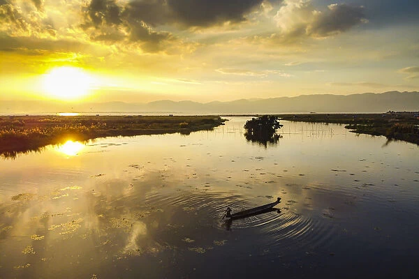 View by drone of rowing boat at sunset, Inle Lake, Shan state, Myanmar (Burma), Asia