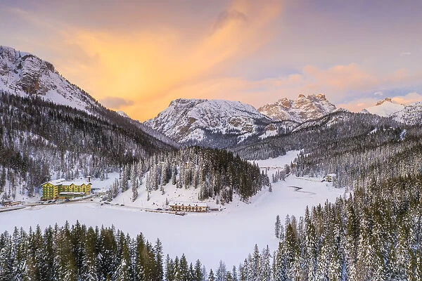 View by drone of sunset over Monte Piana and woods covered with snow, Misurina, Dolomites
