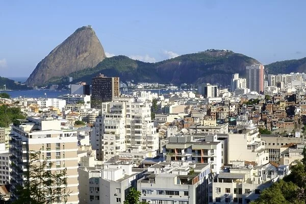 View of a favela with the Sugar Loaf in the background, Rio de Janeiro, Brazil, South