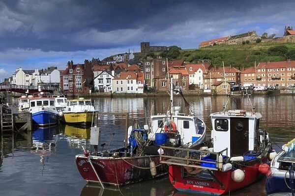 View of fishing boats in the harbour and the town centre, Whitby, Yorkshire, England