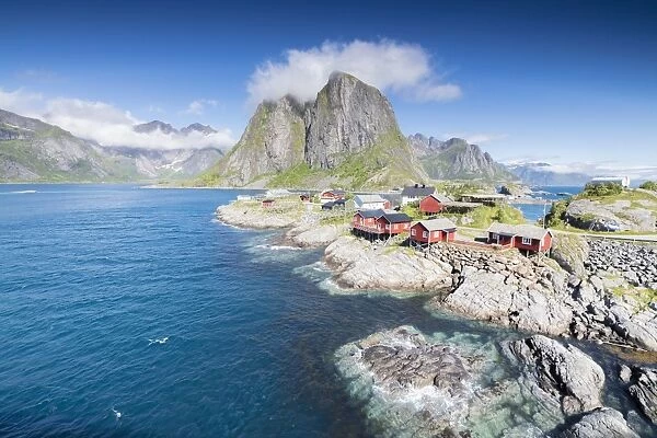 Top view of the fishing village framed by blue sea and high peaks Hamnoy, Moskenesoya