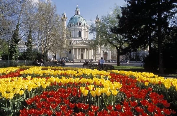 View over flowerbeds of red and yellow tulips to the Karlskirche (church)