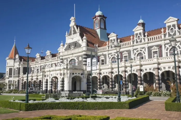 Framed Print : View from gardens to the imposing facade of Dunedin Railway Station, Anzac Square Framed Print : View from gardens to the imposing facade of Dunedin Railway Station, Anzac Square