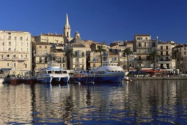 View across harbour to church of Ste. Marie in the early morning, Calvi