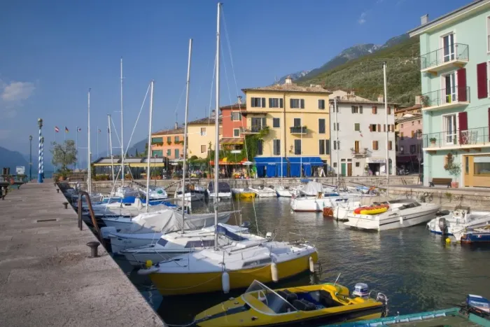 Framed Print : View across the harbour to colourful houses on the shore of Lake Garda Framed Print : View across the harbour to colourful houses on the shore of Lake Garda