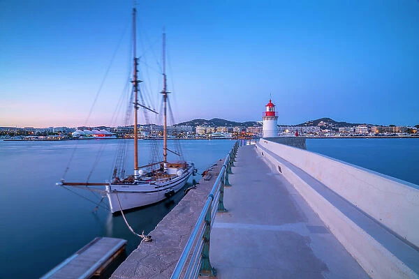 View of harbour lighthouse and sailing ship at dusk, UNESCO World Heritage Site, Ibiza Town, Eivissa, Balearic Islands, Spain, Mediterranean, Europe