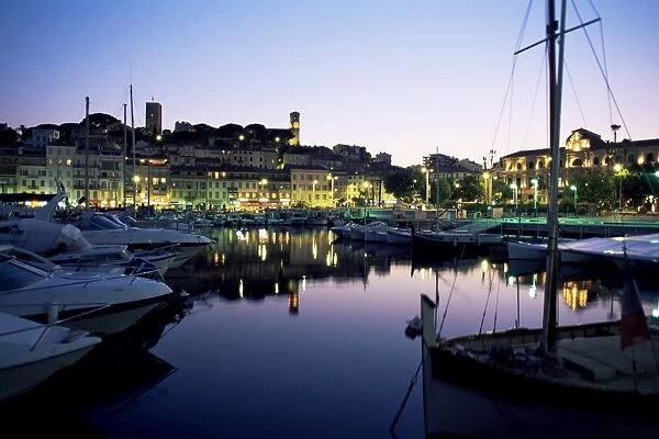 View across harbour to the old quarter of Le Suquet, at dusk, Cannes, Alpes-Maritimes