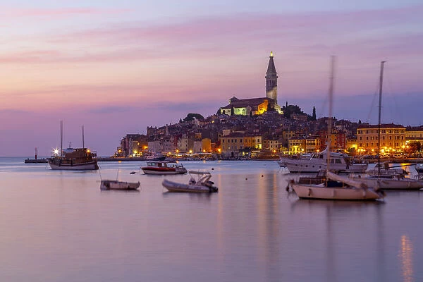 View of harbour and the old town with the Cathedral of St. Euphemia at dusk, Rovinj