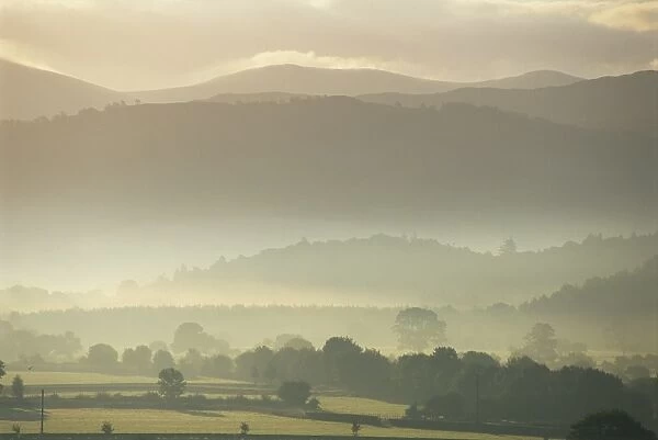 View of hills and landscape in early morning mist, River Derwent Valley