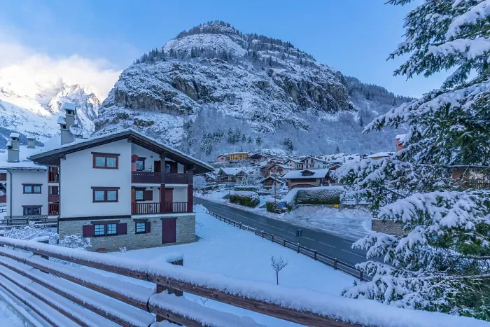 Framed Print : View of hotels, chalets and snow covered mountains in Courmayeur at sunrise in winter, Courmayeur, Aosta Valley, Italian Alps, Italy