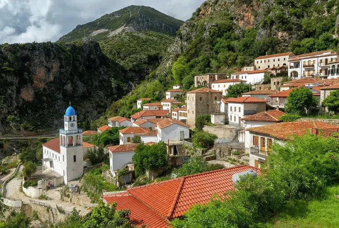 Framed Print : View over houses and rooftops to Greek Orthodox Church of Saint Spyridon, village of Dhermi, Albania, Europe Framed Print : View over houses and rooftops to Greek Orthodox Church of Saint Spyridon, village of Dhermi, Albania, Europe