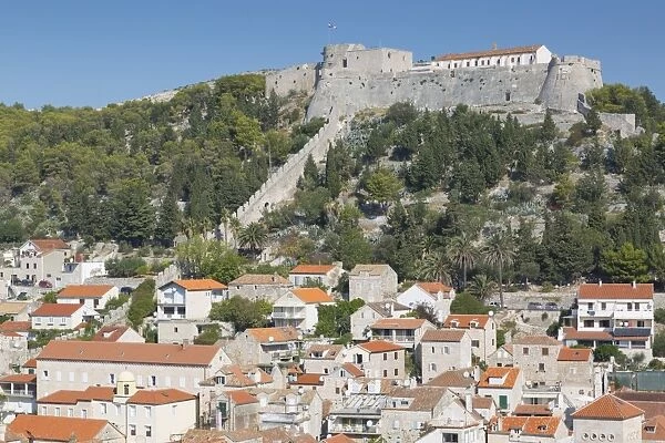 View of Hvar Main Square overlooked by Spanish Fortress, Hvar, Hvar Island, Dalmatia