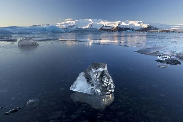 View of icebergs on Jokulsarlon, a glacial lagoon at the head of the Breidamerkurjokull Glacier, with some icebergs illuminated by the afternoon winter sun, on the edge of the Vatnajokull National Park, South Iceland, Iceland, Polar Regions