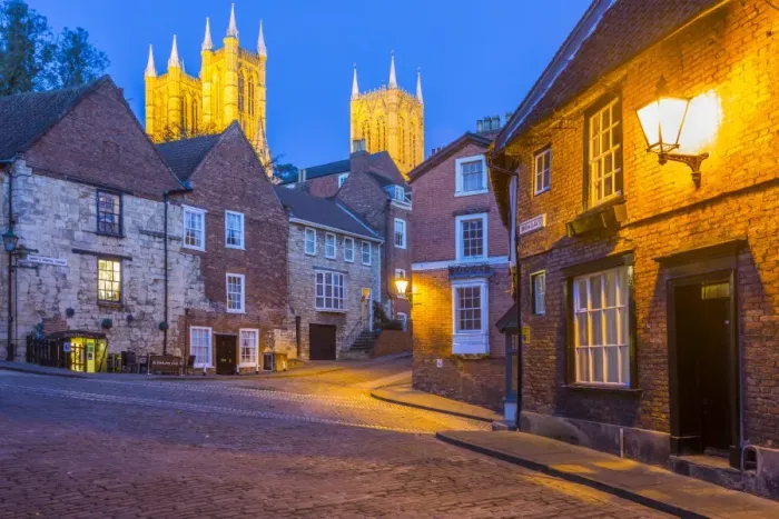 Framed Print : View of illuminated Lincoln Cathedral viewed from the cobbled Steep Hill at dusk Framed Print : View of illuminated Lincoln Cathedral viewed from the cobbled Steep Hill at dusk