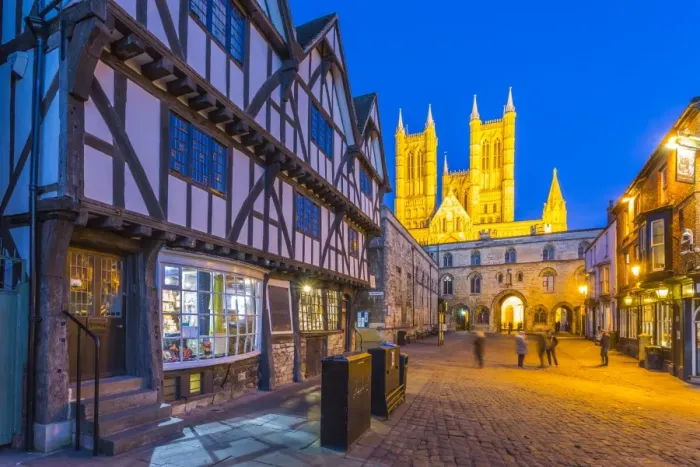 Framed Print : View of illuminated Lincoln Cathedral viewed from Exchequer Gate with timbered architecture Framed Print : View of illuminated Lincoln Cathedral viewed from Exchequer Gate with timbered architecture