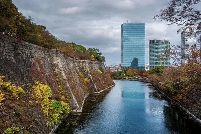 Framed Print : View along the inner Osaka Castle moat with autumnal trees and Crystal tower and CBD in the background, Osaka, Honshu, Japan, Asia Framed Print : View along the inner Osaka Castle moat with autumnal trees and Crystal tower and CBD in the background, Osaka, Honshu, Japan, Asia