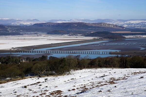 View of Lakeland fells and Kent estuary from Arnside Knott in snow, Cumbria