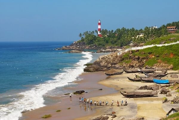 View to the Lighthouse with fishermen, Kovalam, Kerala, India, Asia