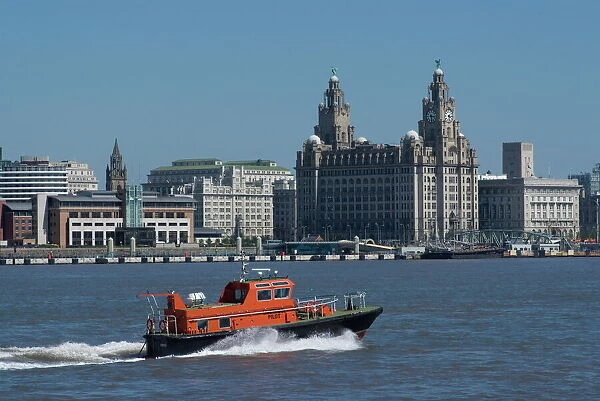 View of the Liverpool skyline and the Liver building, with a pilot boat in the foreground