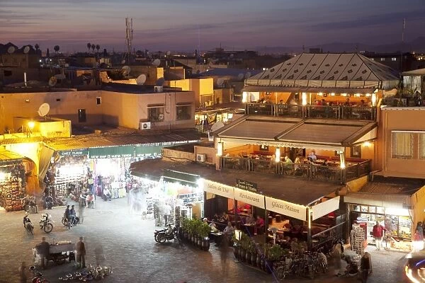 View over market square at dusk, Place Jemaa El Fna, Marrakesh, Morocco, North Africa, Africa