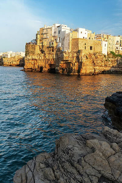 View of the medieval village of Polignano a Mare on top of the cliff at sunset, Bari, Apulia, Adriatic Sea, Mediterranean Sea, Italy, Europe