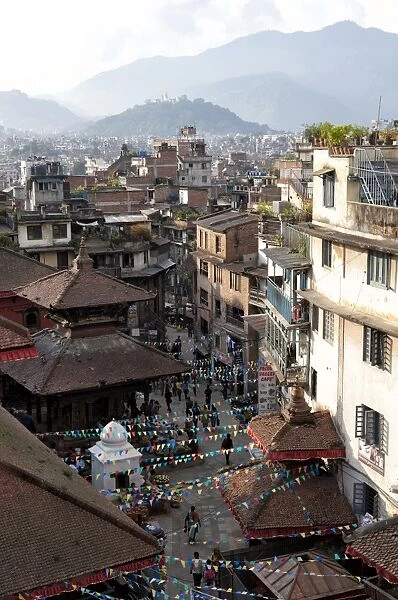 View over narrow streets and rooftops near Durbar Square towards the hilltop temple of Swayambhunath, Kathmandu