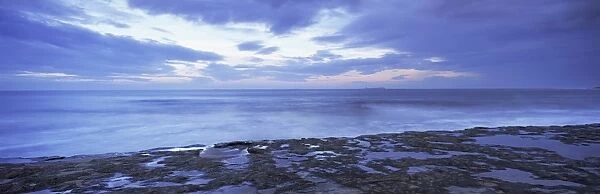 View across North Sea towards Farne Islands at dusk, from Bamburgh, Northumberland