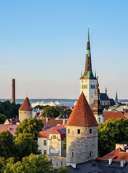 View over the Old Town towards St. Olafs Church at sunset, UNESCO World Heritage Site, Tallinn, Estonia, Europe