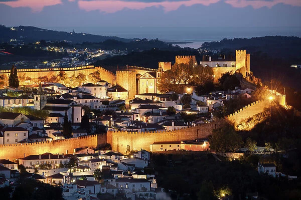 View over the old town and walls of Obidos floodlit at night, Obidos, Centro Region, Estremadura, Portugal, Europe
